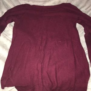 a maroon sweater